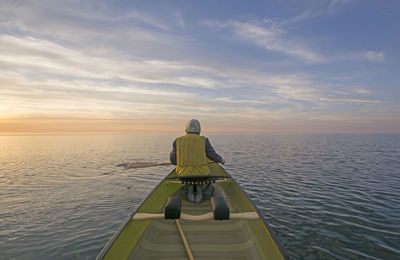 Enjoying the sunset from the canoe on lake superior in mclain state park in michigan