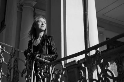 Low angle view of young woman looking away