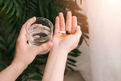 High angle view of woman hand holding glass