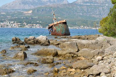 Ship wreck stranded on sea rocks and a seascape