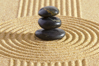 Japanese zen garden with stacked stones in textured sand