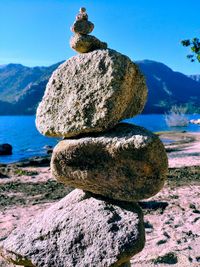 Close-up of rocks on shore against sky