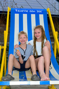 Children in a big chair in renesse in the netherlands