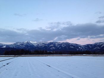 Scenic view of snow covered mountains against sky