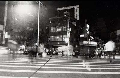 People on road in city at night