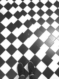 Low section of person standing on tiled floor