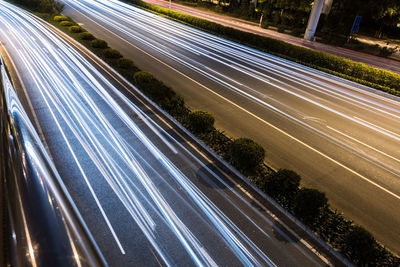 High angle view of light trails on highway in city