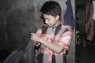 Boy looking into bag at home