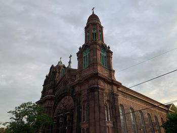 Low angle view of clock tower against sky