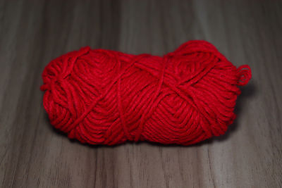 Close-up of red rose on table