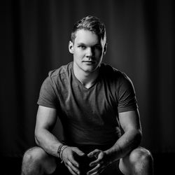 Portrait of handsome young man sitting indoors