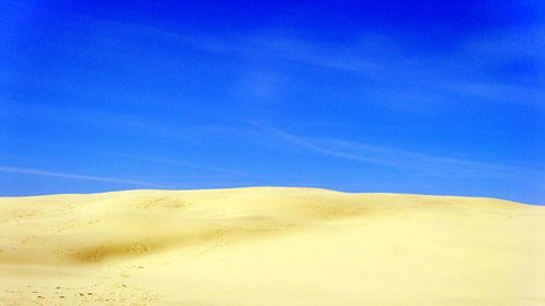 Scenic view of landscape against blue sky