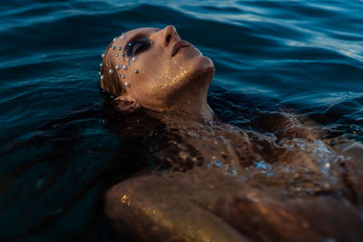 Low section of man swimming in sea