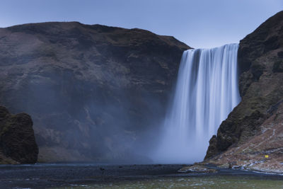 Scenic view of waterfall against clear sky