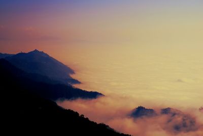 Scenic view of mountains against sky at sunset