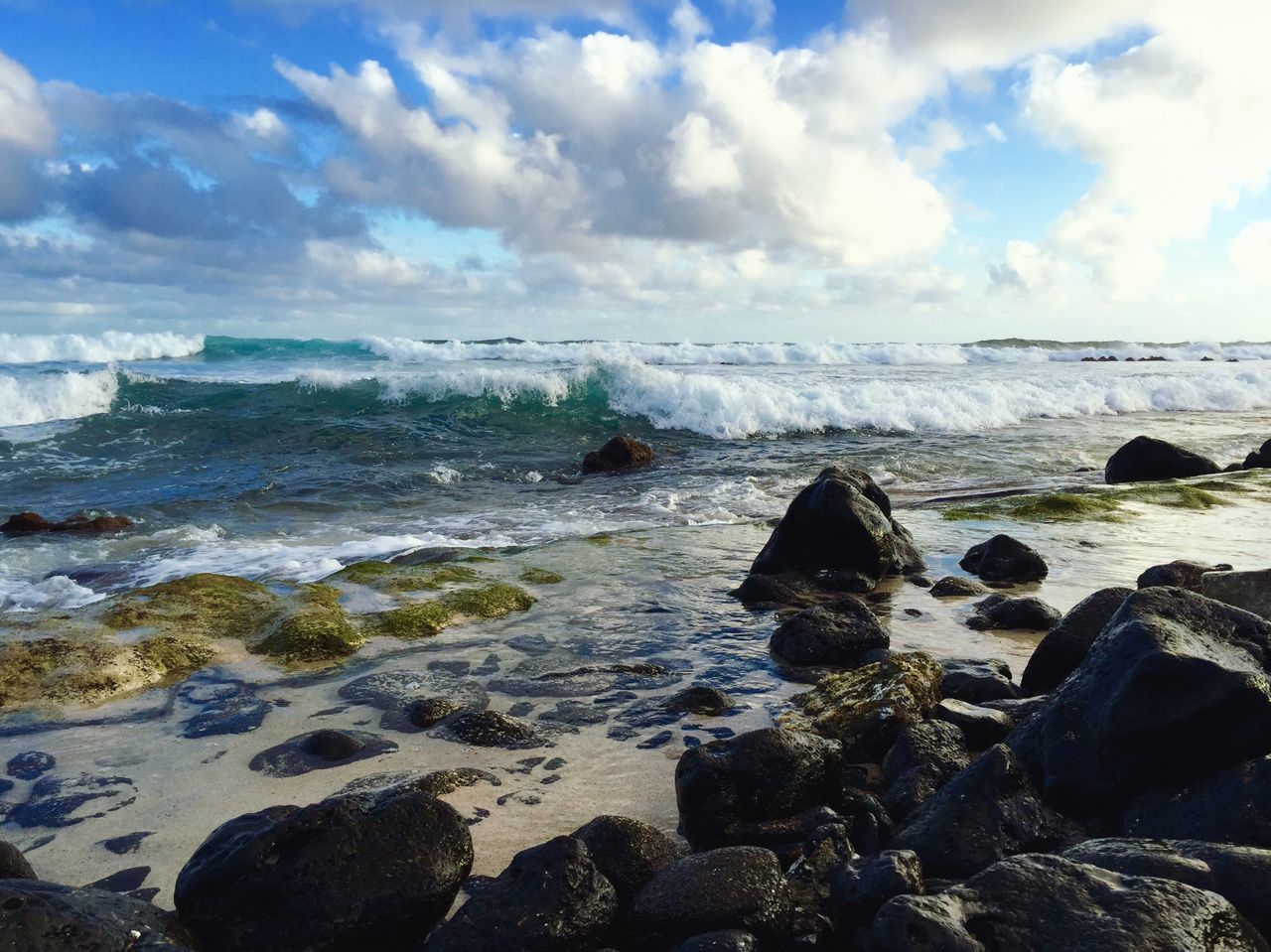 ROCKS ON BEACH AGAINST SKY