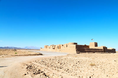 Scenic view of beach against clear blue sky