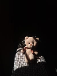 Close-up of stuffed toy on bed in dark