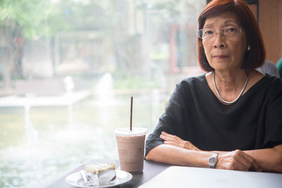 Portrait of woman sitting at table