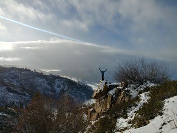 Snow covered landscape against sky