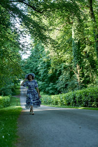 Rear view of man walking on road