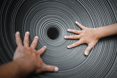 Directly above shot of human hand touching finger