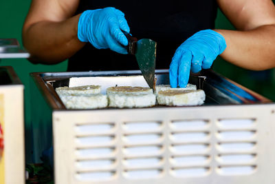 Midsection of man preparing food