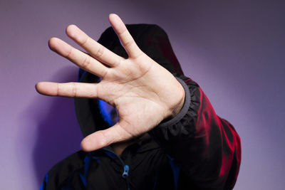 Close-up of person hand against black background