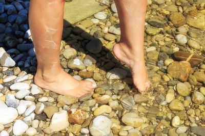 Low section of person standing on rock