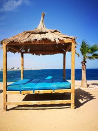 Built structure on beach against blue sky