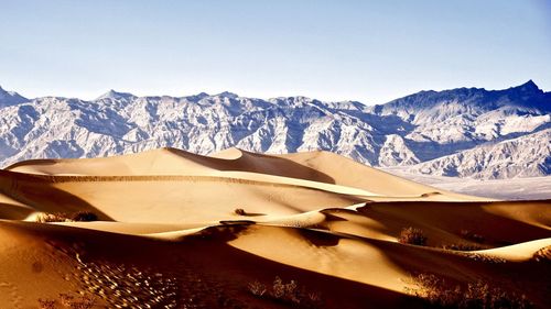 Scenic view of snowcapped mountains against clear sky