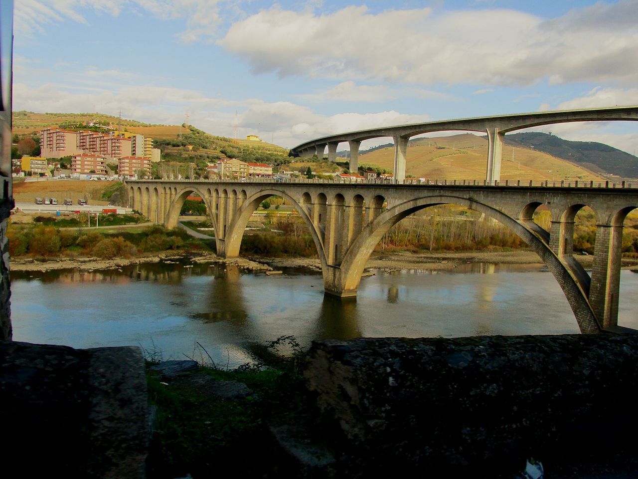 architecture, built structure, connection, bridge - man made structure, water, sky, bridge, river, cloud - sky, arch bridge, building exterior, engineering, arch, cloud, transportation, outdoors, city, no people, day, reflection