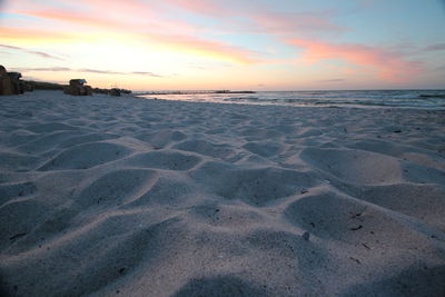 Scenic view of beach against sky during sunset