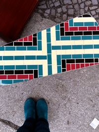 Low section of woman standing on tiled floor