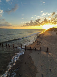 Scenic view of beach against sky during sunset