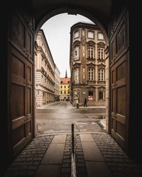 Empty alley amidst buildings in city