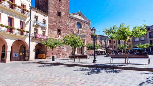 Buildings in town against blue sky