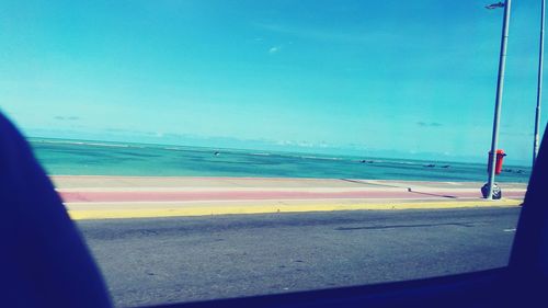 Scenic view of beach against clear blue sky