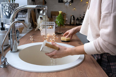 Midsection of woman having food on table