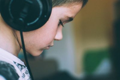 Side view of boy with headphones at home