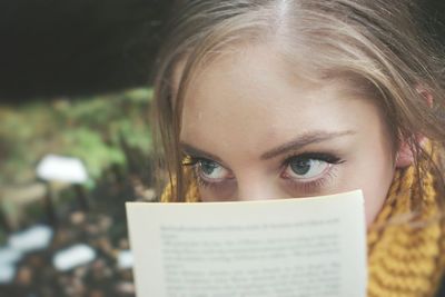 Close-up of young woman holding eyeglasses