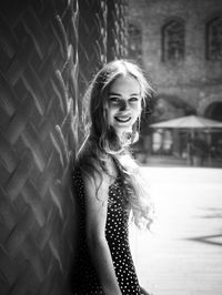 Portrait of a smiling young woman standing outdoors