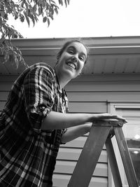 Side view of a smiling girl standing outdoors