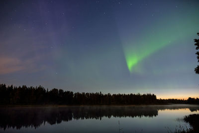 Scenic view of lake against sky at night