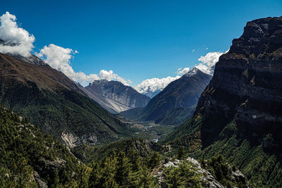 Scenic view of mountains against blue sky