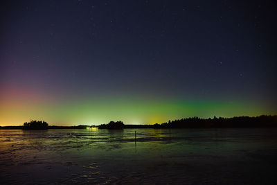 Scenic view of lake against sky at night