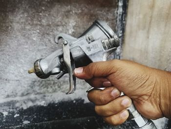 Close-up of hand holding spray paint