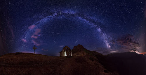 Panoramic view of mountains against sky at night