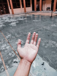 High angle view of person hand on tiled floor