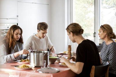 Family having meal at dining table